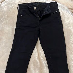 Express black skinny jeans with fashionable zippers on the sides of ankle